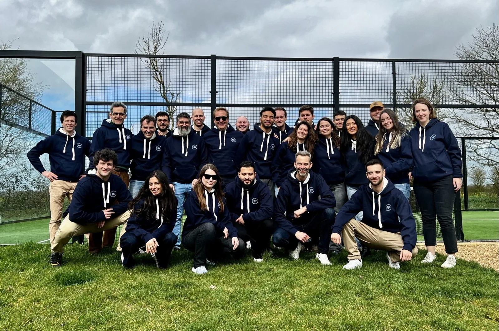 The MyC team gathered outdoors in team hoodies